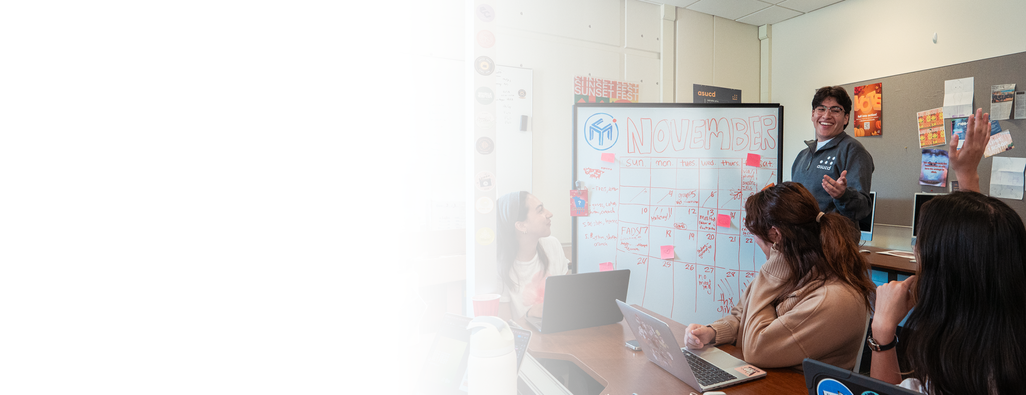 Image of project manager working with their team in front of a white board