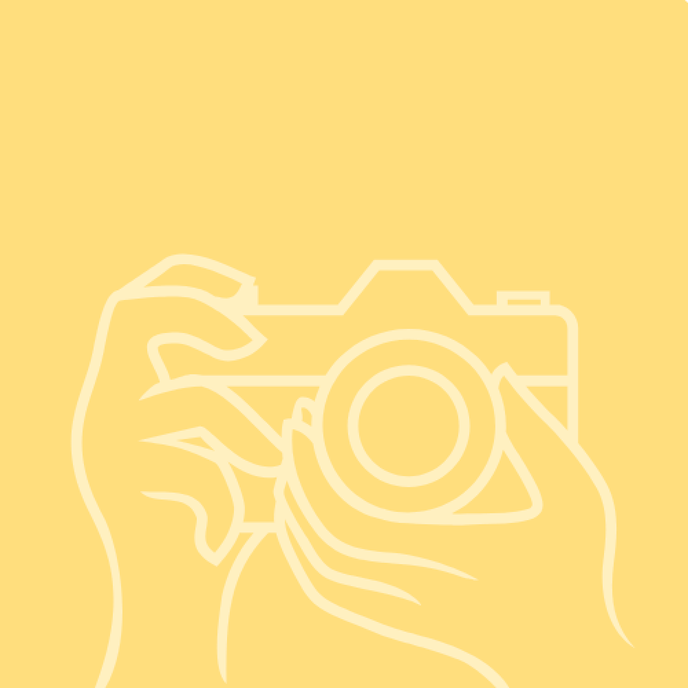 Two hands holding a camera in front of a gold background